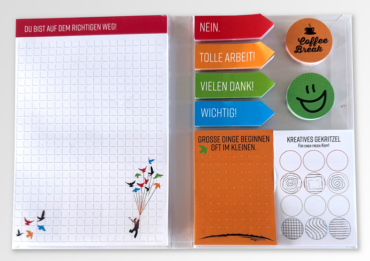 Notizbuch mit kreativen Notizzetteln und Indexmarkern